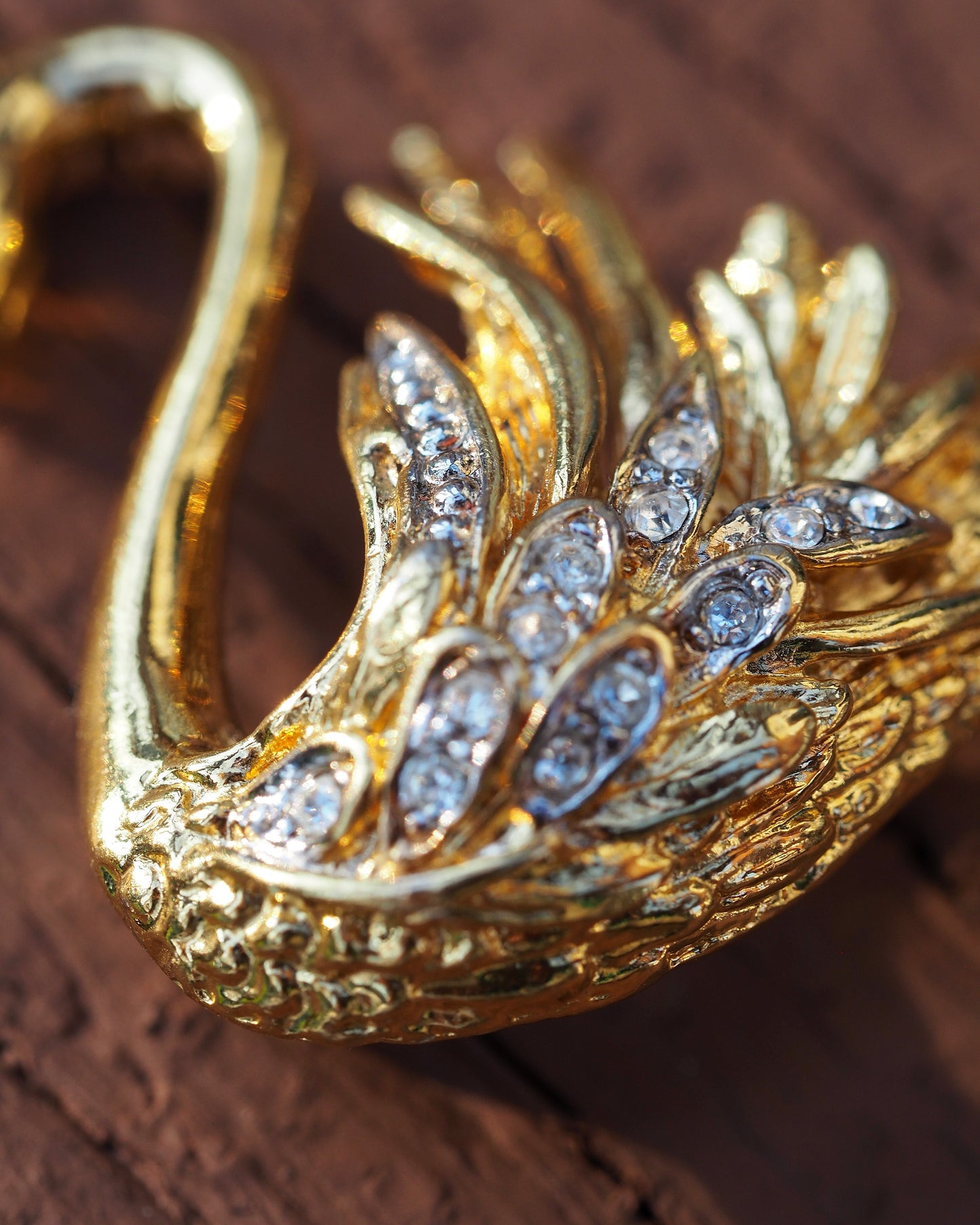 Close-up detail of rhinestones set in rows along the swan's wings and body