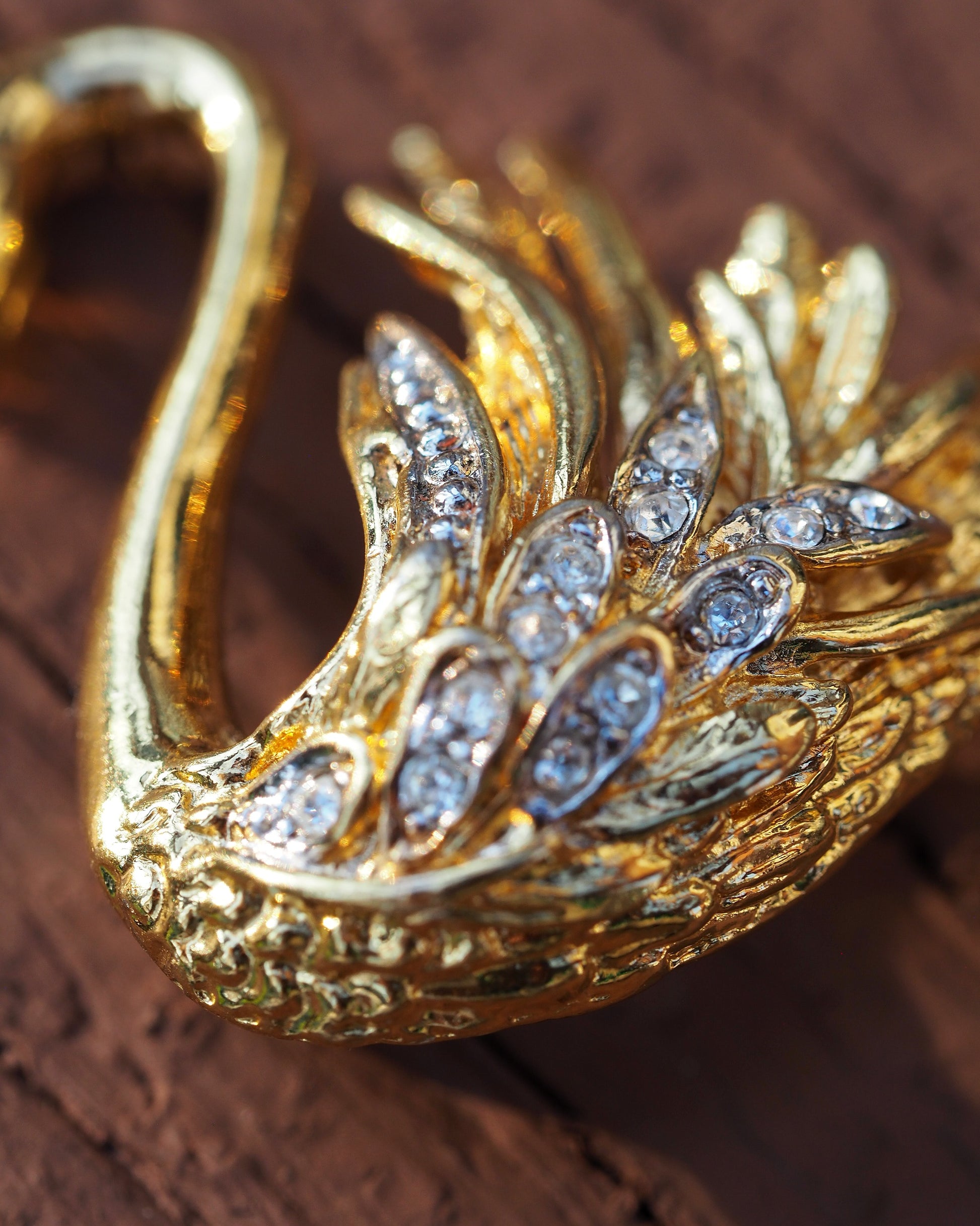 Close-up detail of rhinestones set in rows along the swan's wings and body