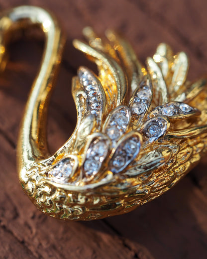 Close-up detail of rhinestones set in rows along the swan's wings and body