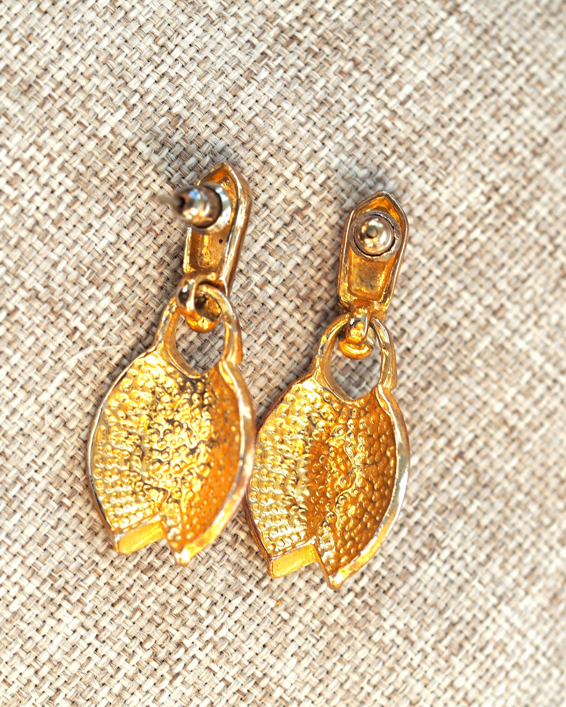 Gold-tone faux pearl earrings shown from the back with post and butterfly backs visible