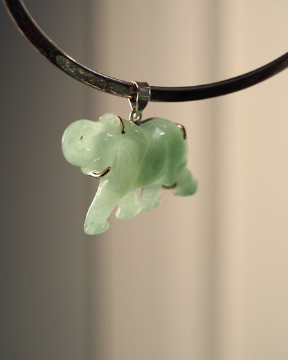 Sterling silver aventurine elephant pendant hanging from black cord, front view showing raised trunk and pale green translucent stone