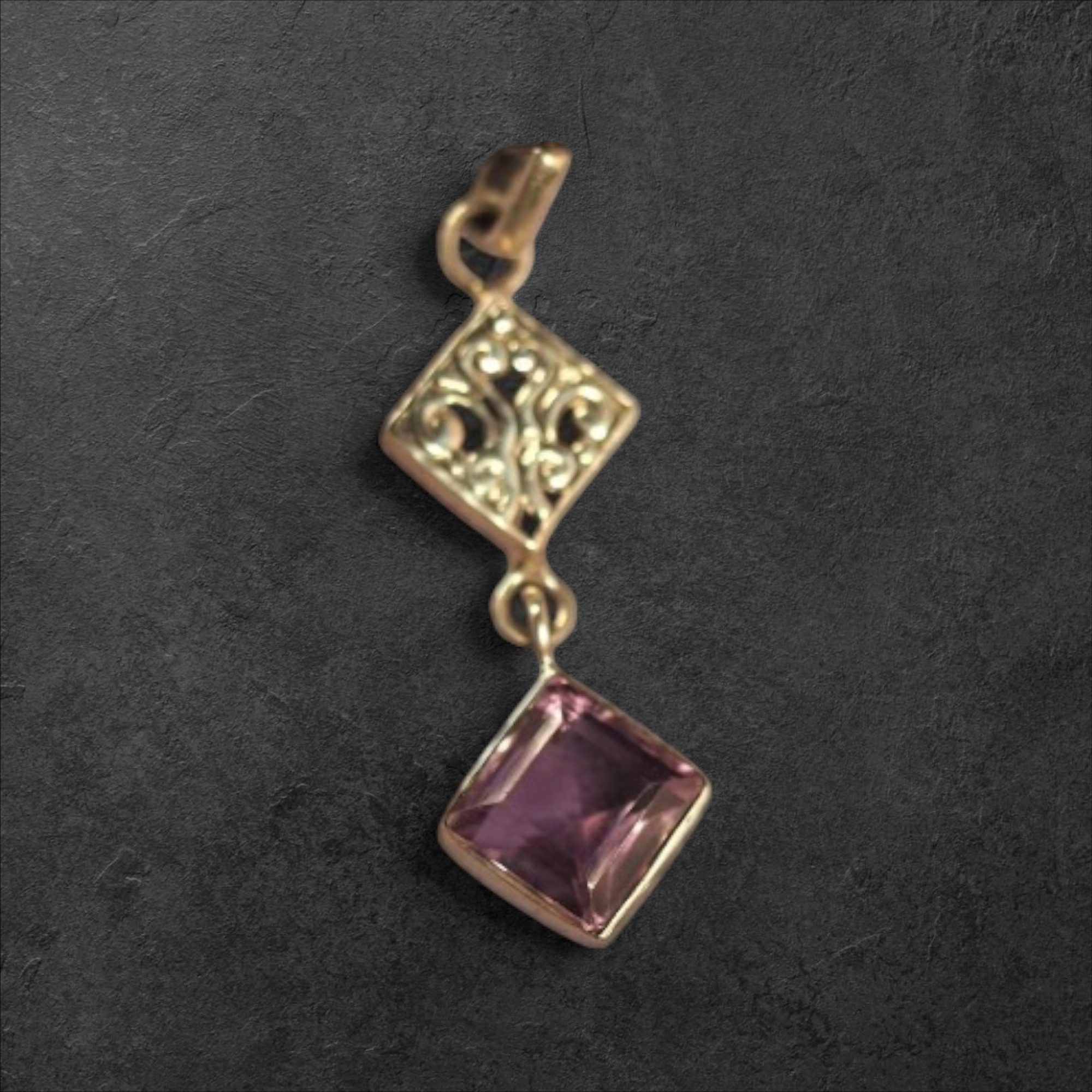 GlamGram NYC sterling silver filigree diamond pendant with a faceted purple gemstone on a dark textured background.