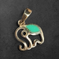 GlamGram NYC sterling silver elephant pendant charm with a vibrant turquoise inlay on a dark textured background.
