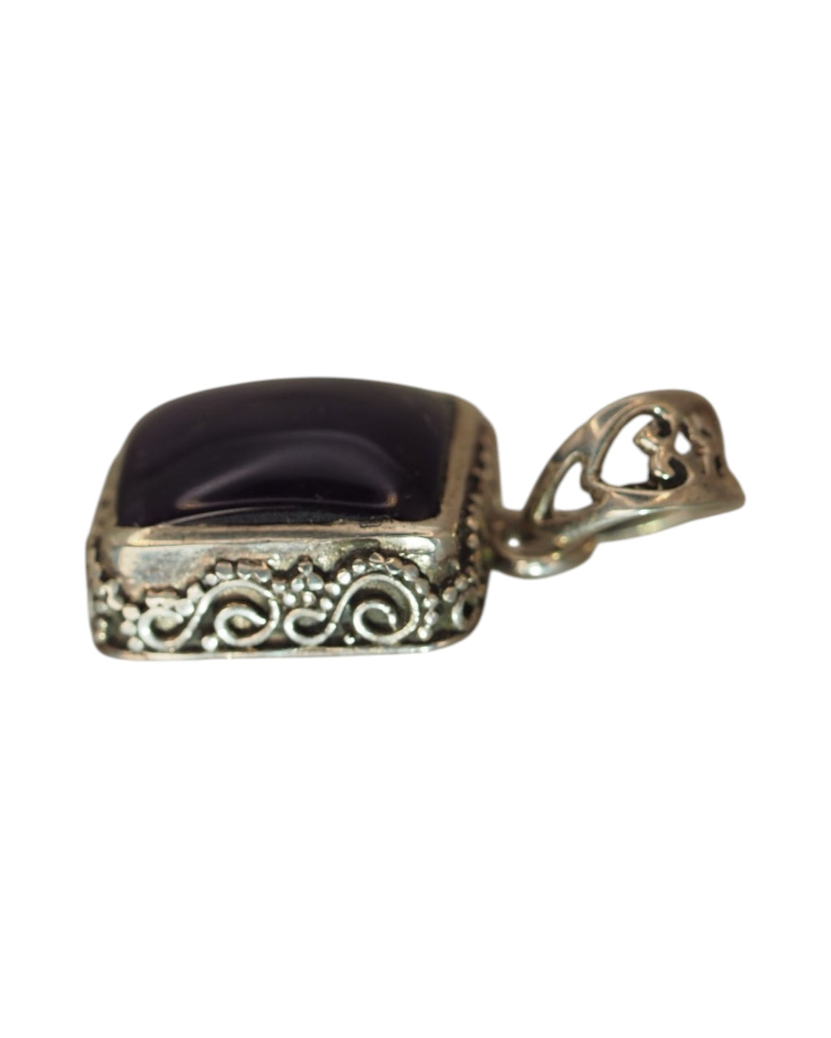Angled side view of rectangular amethyst pendant showing openwork detail and bail