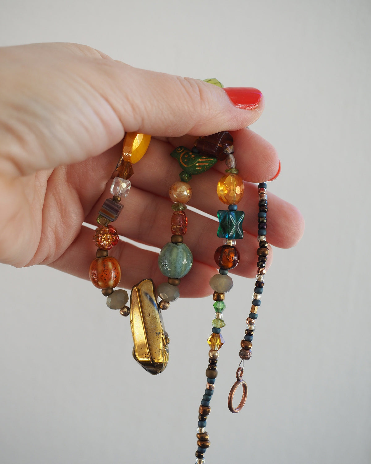 GlamGram Original mixed glass bead necklace held for scale