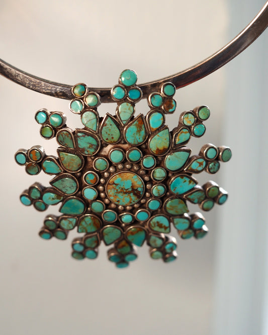 Large turquoise cluster sunburst pendant, front view on a silver collar; collar not included