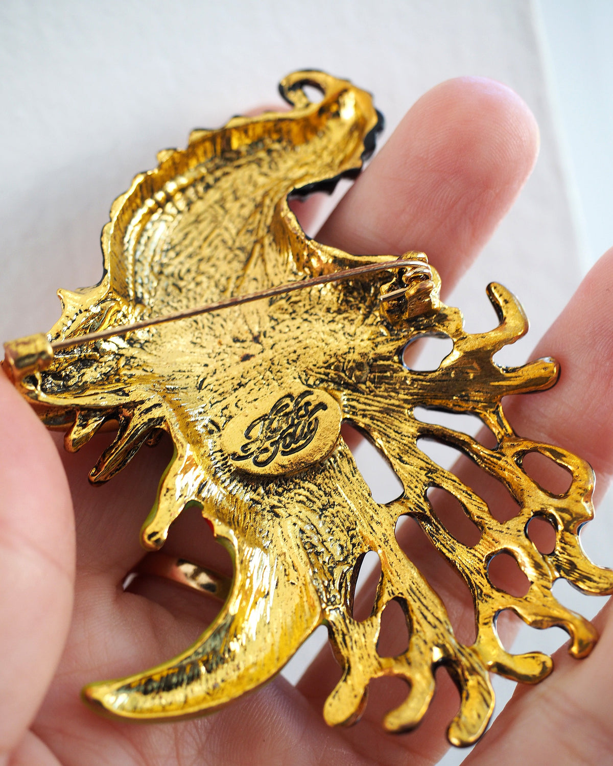 Back of Kirks Folly witch brooch showing pin clasp and signature