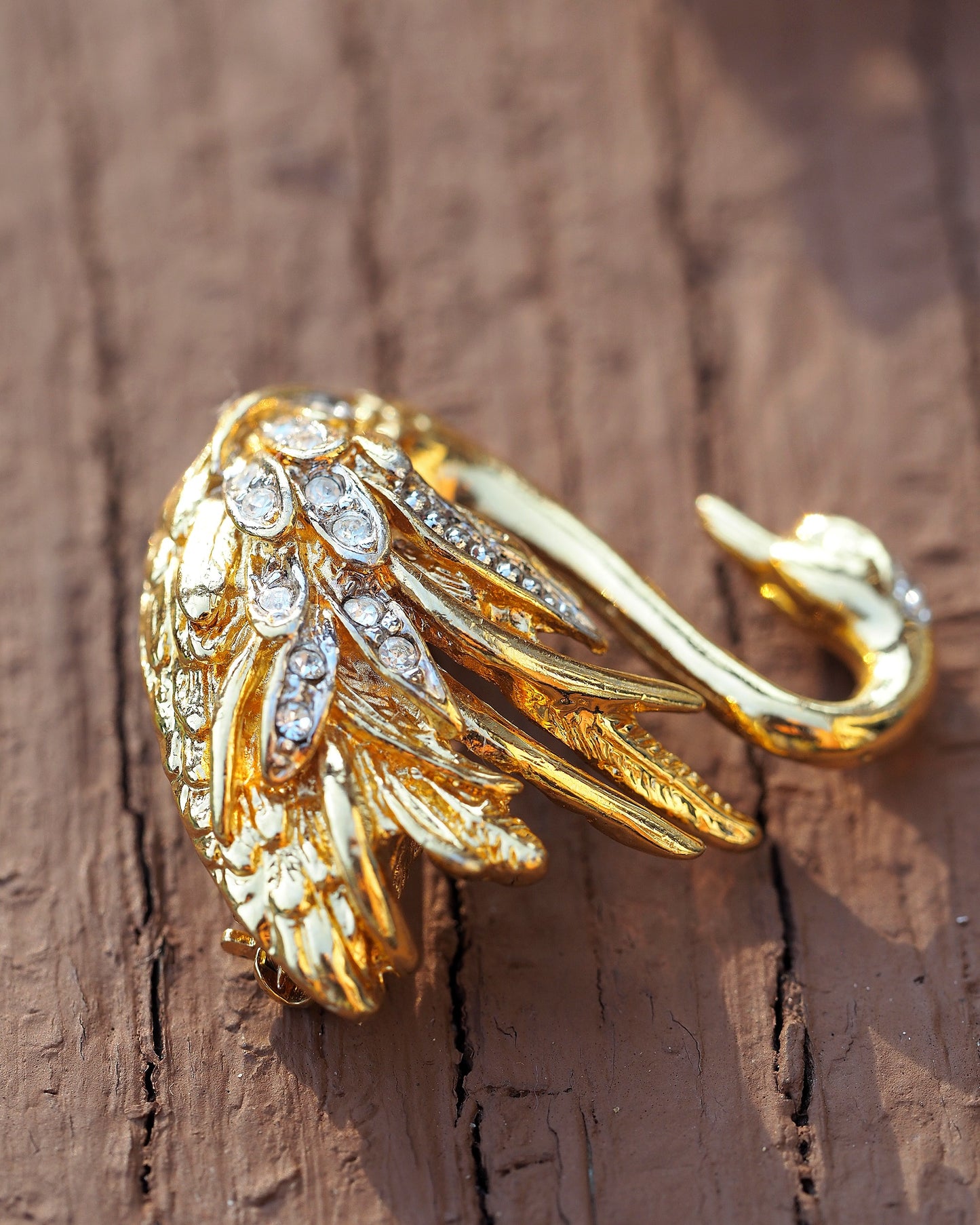 Side angle view of Marvella swan brooch showing three-dimensional relief and feather texture