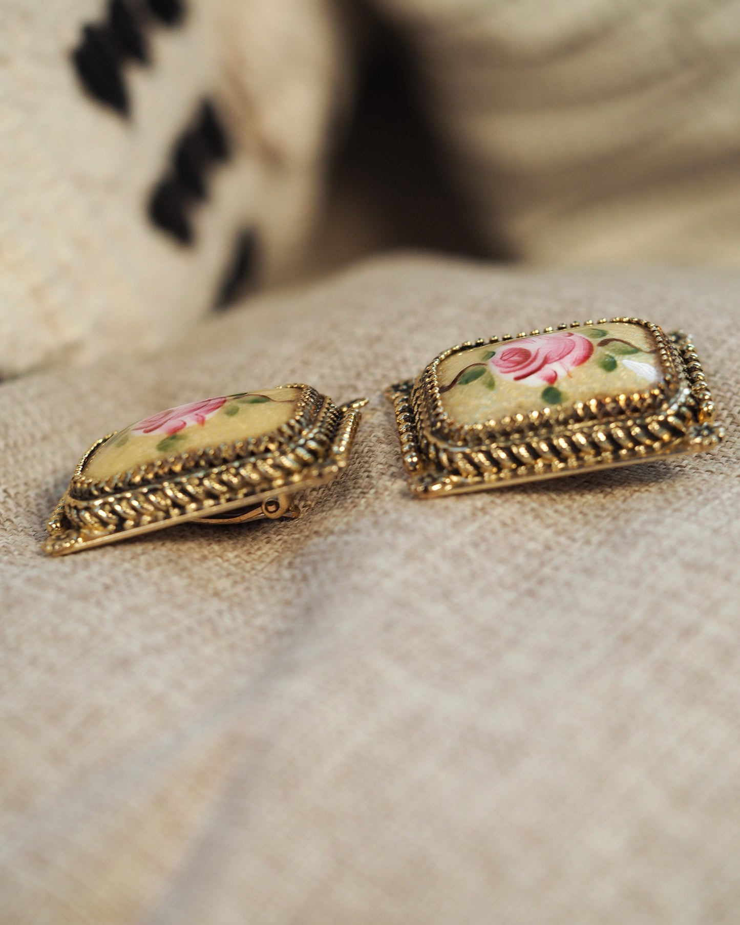 Side angle view of the earrings showing the domed porcelain insets and three-tier beaded metal frames