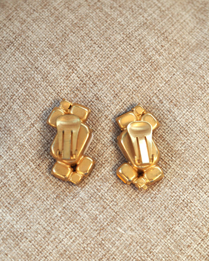 Reverse side of both earrings showing the gold-tone metal backs and clip-on closures