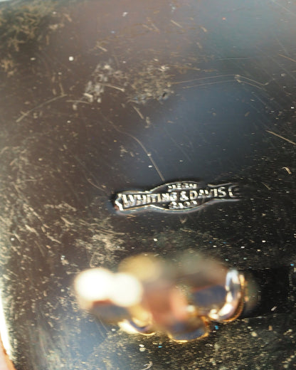 Close-up of Whiting & Davis hallmark stamp on the reverse of one clip-on back