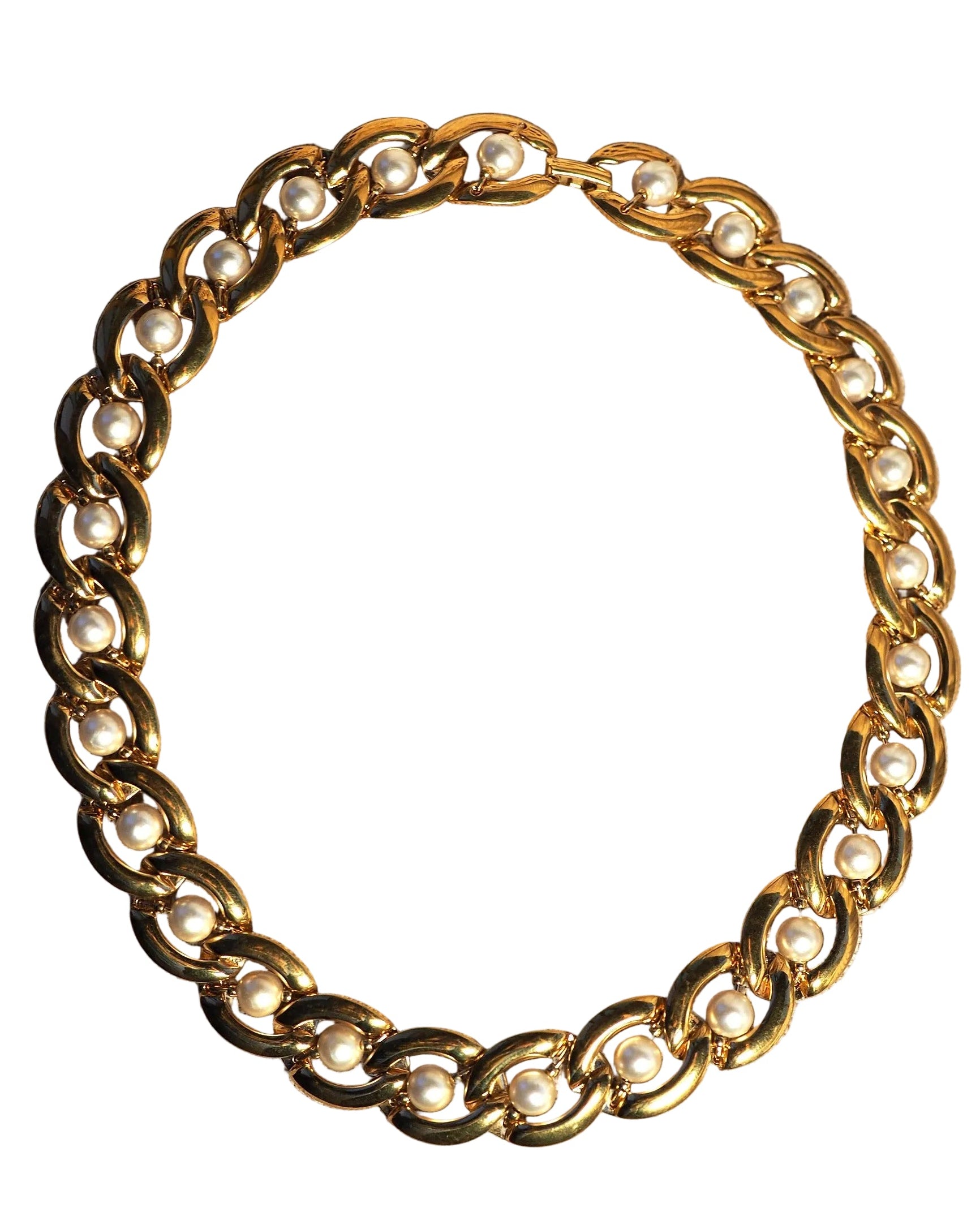 Back view of Napier necklace showing continuous pearl-studded chain construction on linen
