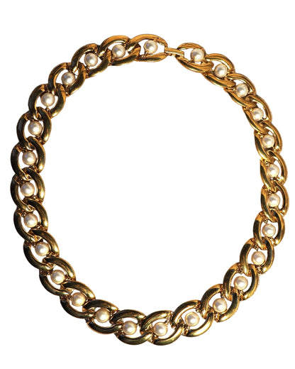 Back view of Napier necklace showing continuous pearl-studded chain construction on linen