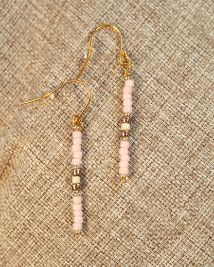 Back view of handmade pink glass bead drop earrings showing gold-tone fishhook ear wires and beaded construction