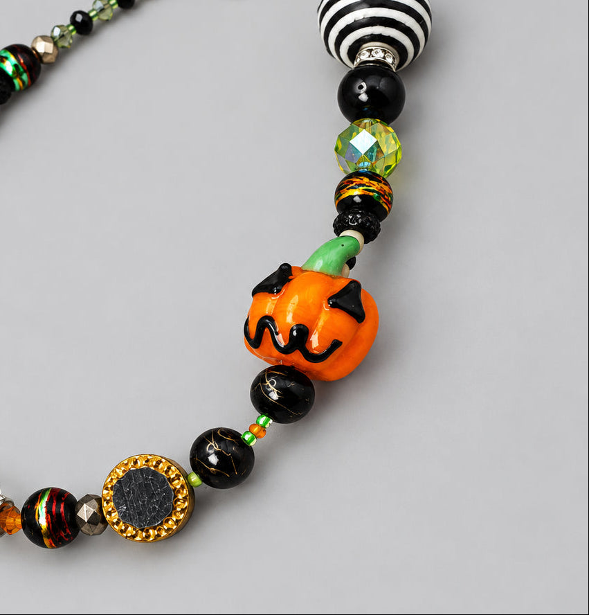 Orange glass pumpkin bead with striped and faceted glass beads on GlamGram Original Halloween necklace