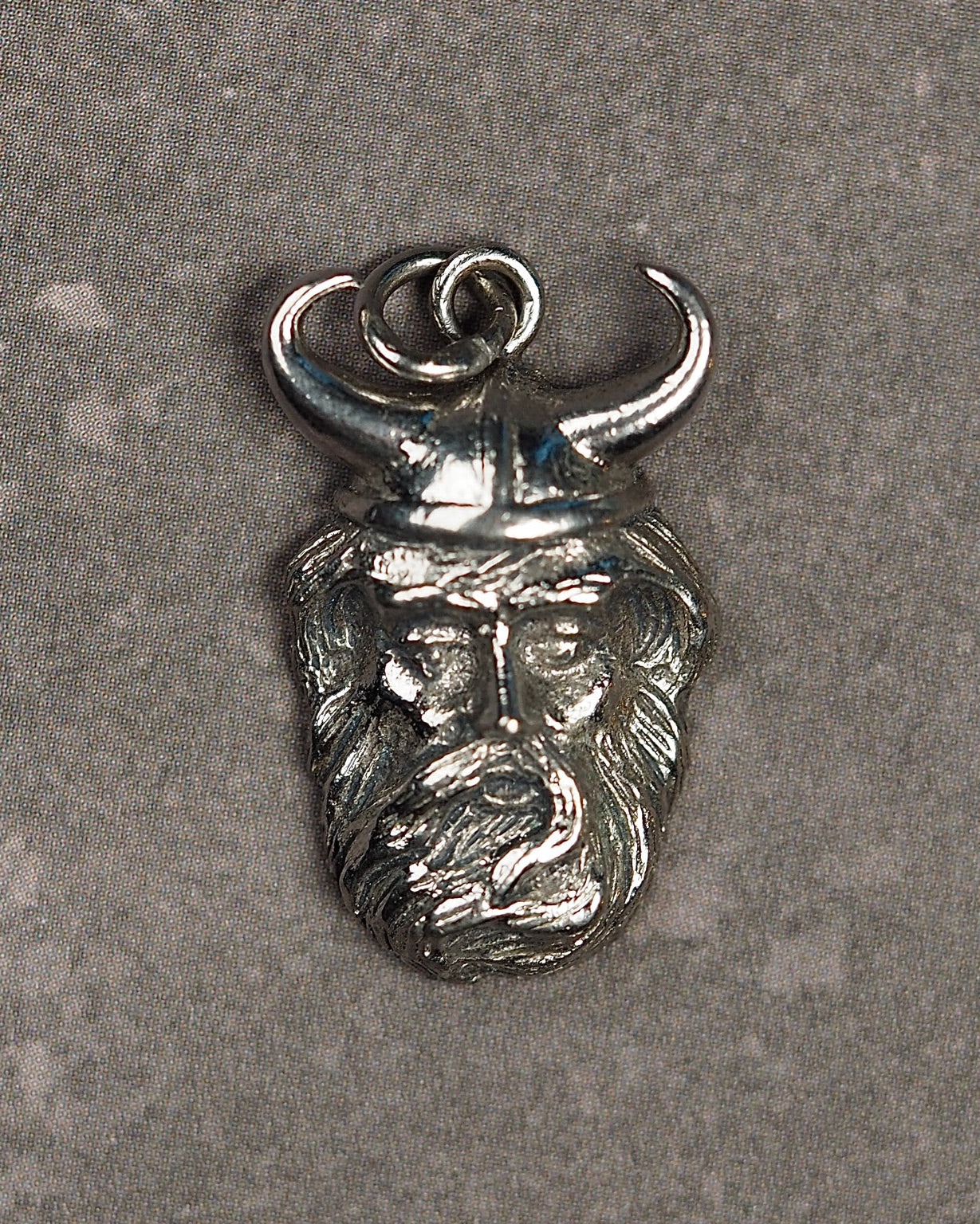 Front view of vintage Kinney sterling silver Viking head charm pendant
