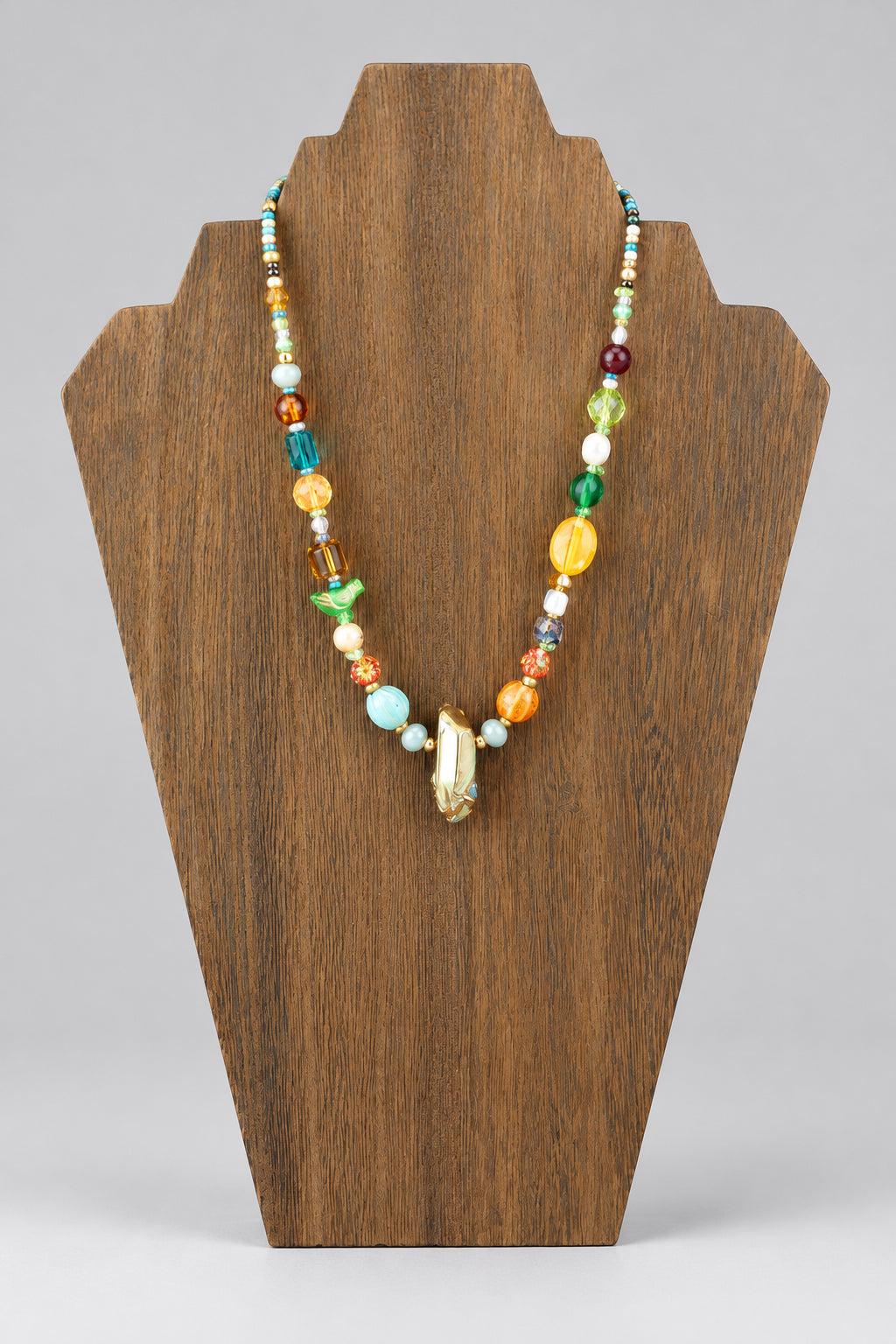 GlamGram Original mixed Czech and Japanese glass bead necklace on wood stand, front view