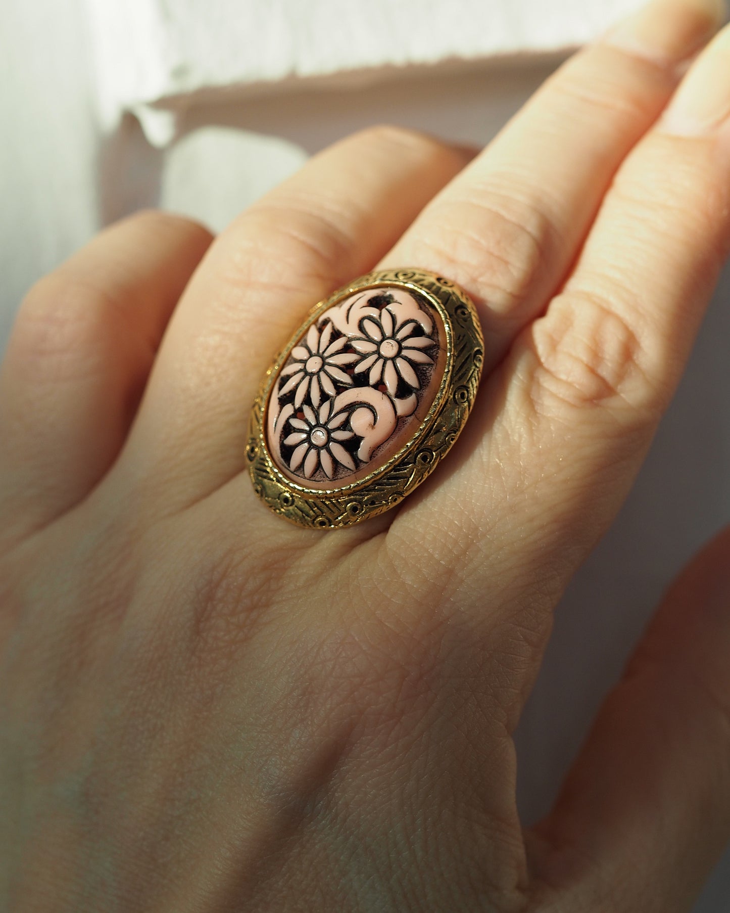 Ring worn on finger for scale, showing size and height of oval cabochon against hand