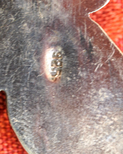 Close-up of 925 stamp on back of sterling silver butterfly pendant