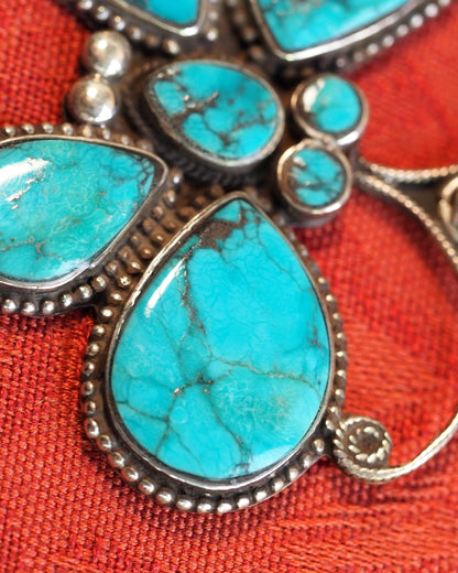 Detail of seven turquoise cabochons and decorative sterling silver beadwork
