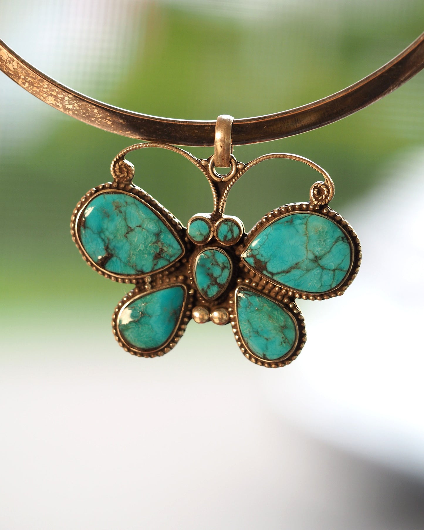 2000s sterling silver reconstituted turquoise butterfly pendant shown on silver collar; pendant only