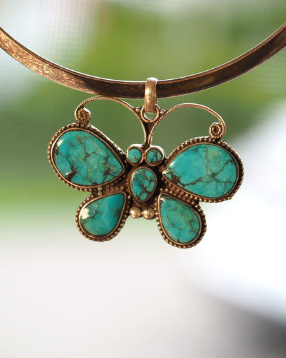 2000s sterling silver reconstituted turquoise butterfly pendant shown on silver collar; pendant only